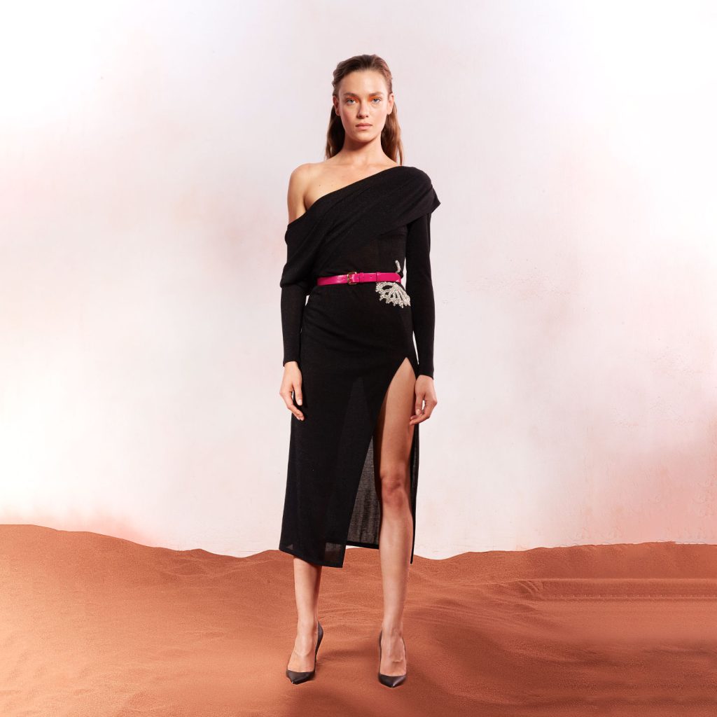 Short nit dress with long sleeves and draped layered off one shoulder bust , dandelion crystal detail and leather belt.