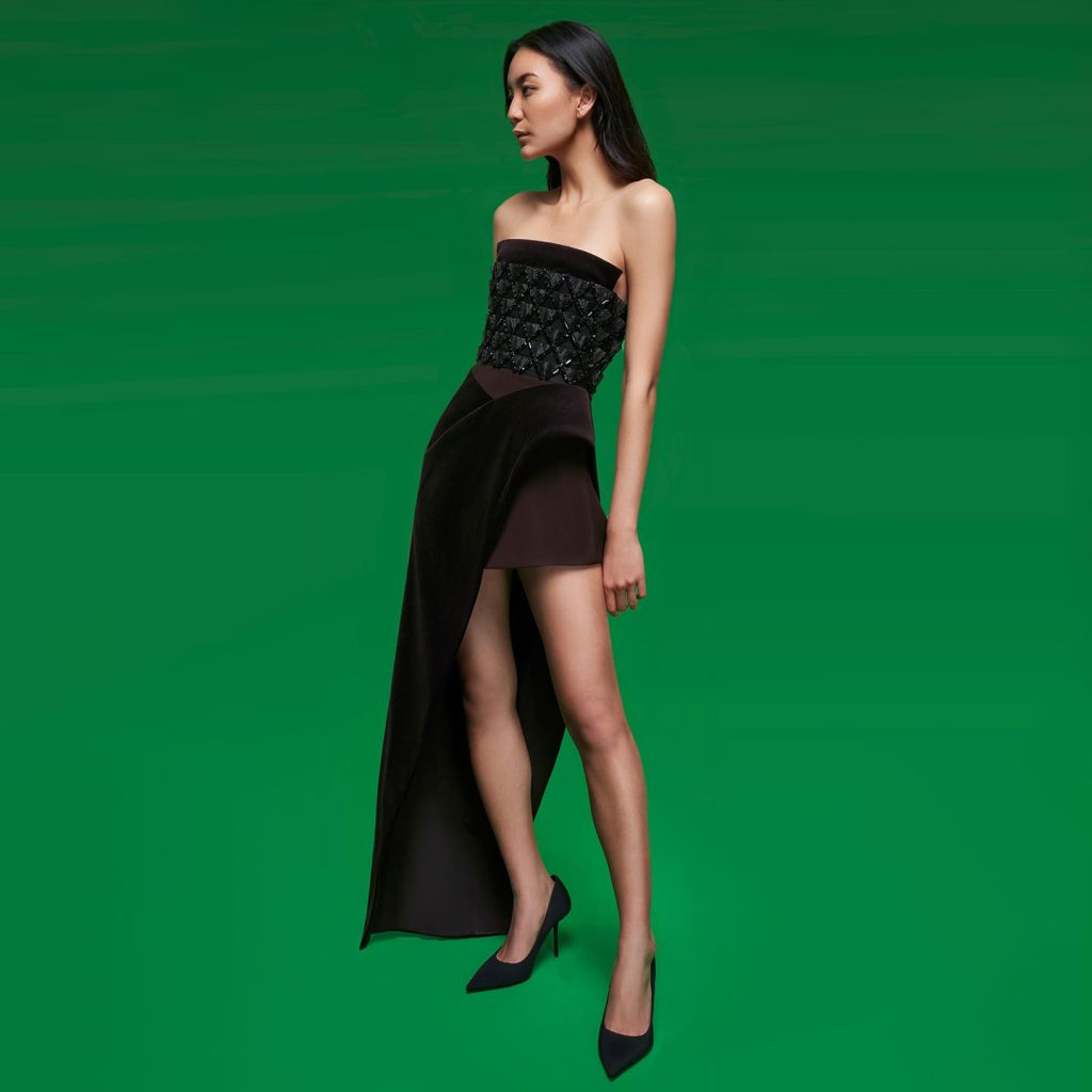 Strapless long dress with structured sharp bust made of 3d metal work embroidery and structured long slit skirt with detail under skirt enhancing the waist.