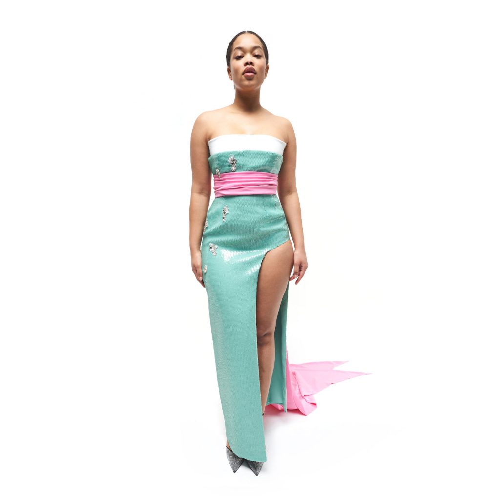 Strapless structured layered dress, tricolored waist drape extending to back bow and long tails, with a square shaped asymmetric crop jacket.