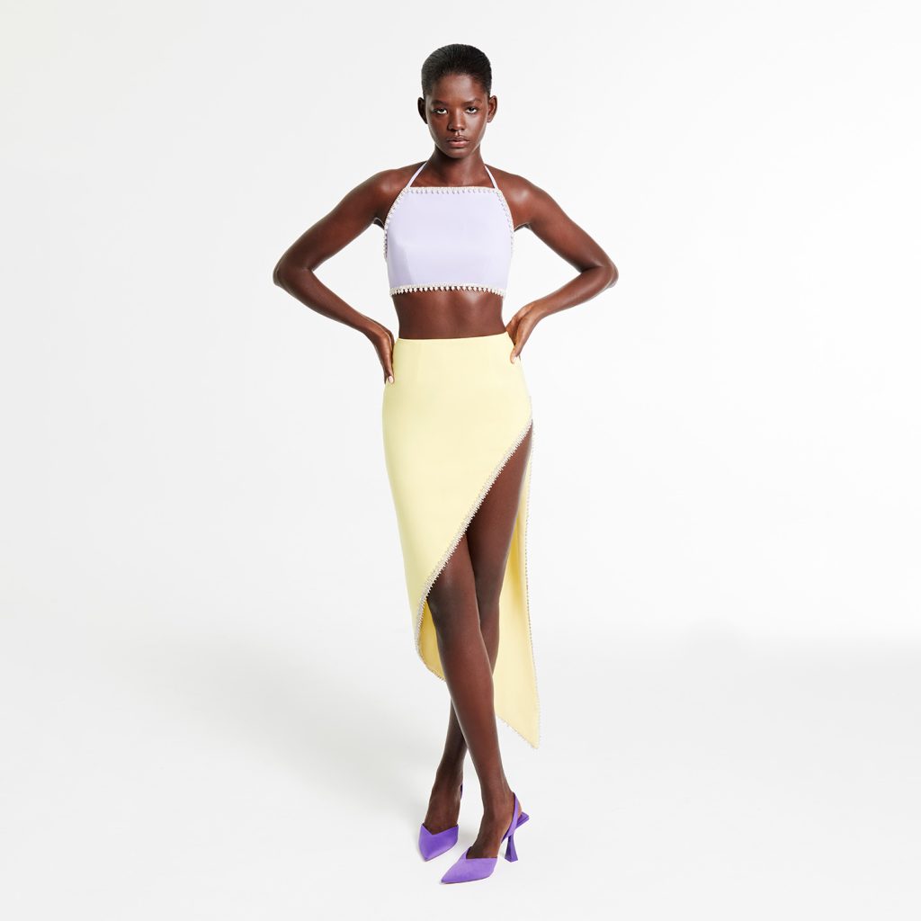 Halter neck crop top with crystal and pearl trim, and a midi skirt with high slit, pearl and crystal trim.