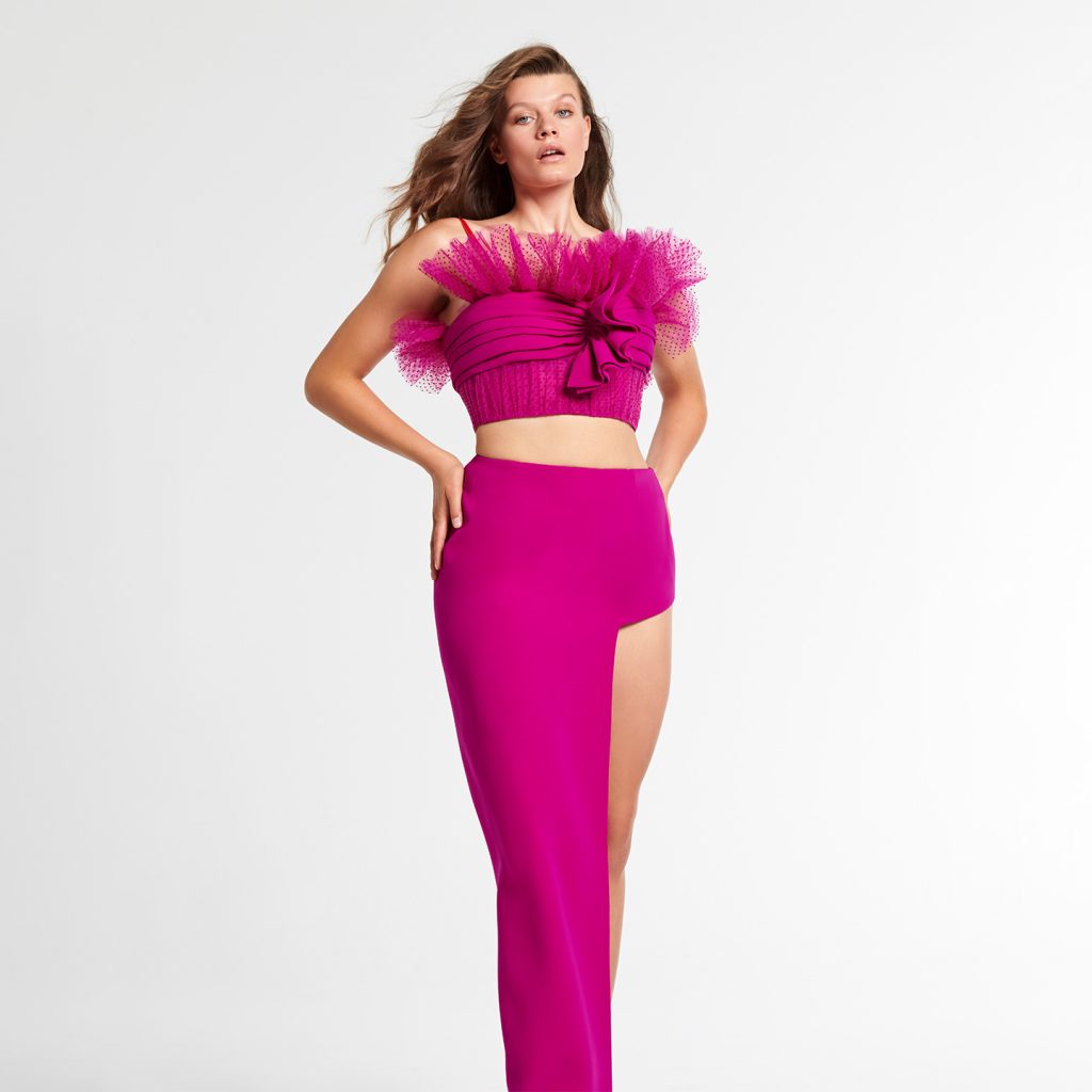 Ruffled corseted top, a long Skirt with square high slit.