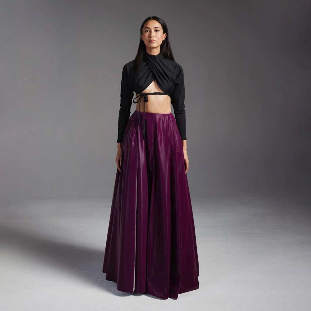 Cropped draped long sleeve knit top, with open back, and exaggerated long latex skirt with slit in middle.