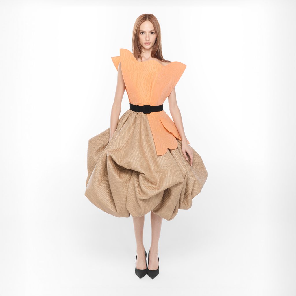 Scalloped asymmetrical tulip shaped bust in brocade and exaggerated bubble skirt in raffia.